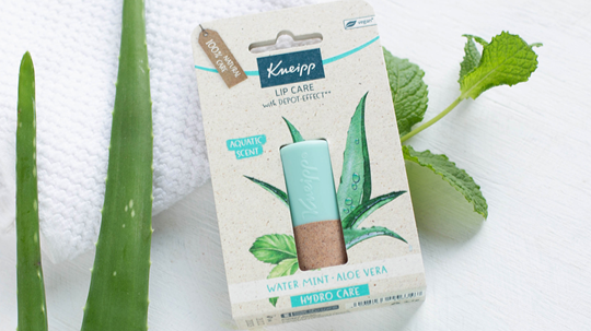 Kneipp Water Mint Aloe Vera Lip Care showcased with packaging, aloe leaf, mint leaf, and textured towel, emphasizing a fresh, moisturizing experience.