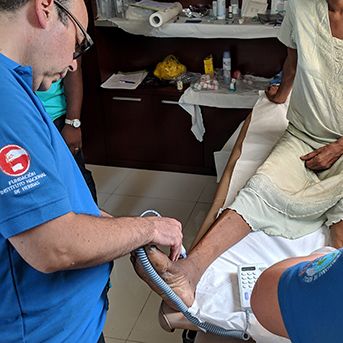 man measures on the foot of a woman